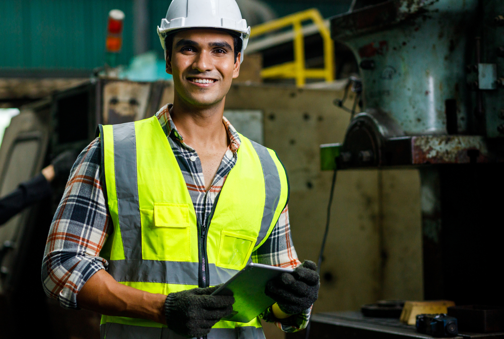 portrait,of,smile,male,indian,engineer,is,holding,the,tablet