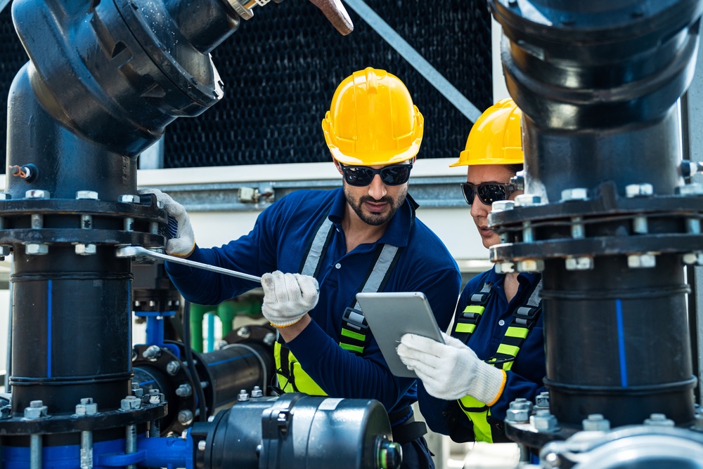 industrial,technicians,operating,large,pipeline,valves,during,cooling,tower,system